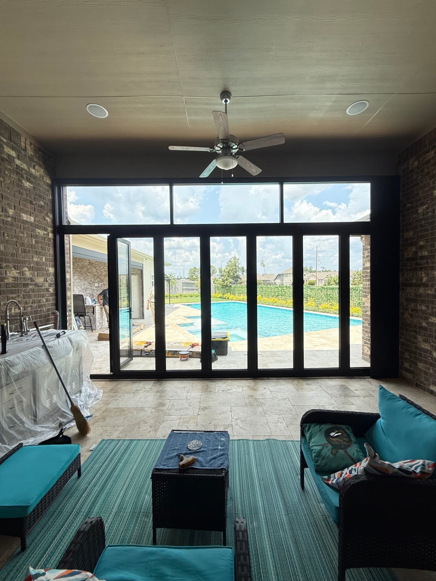 The Woodlands TX bifold door and transom window enclosure interior view overlooking the pool