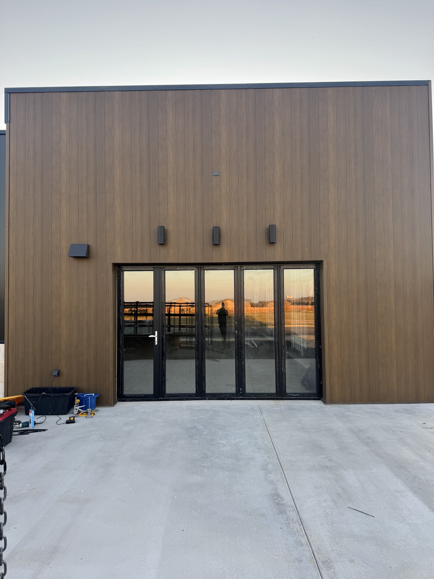 Large-scale bifold doors on warehouse facade — industrial commercial application