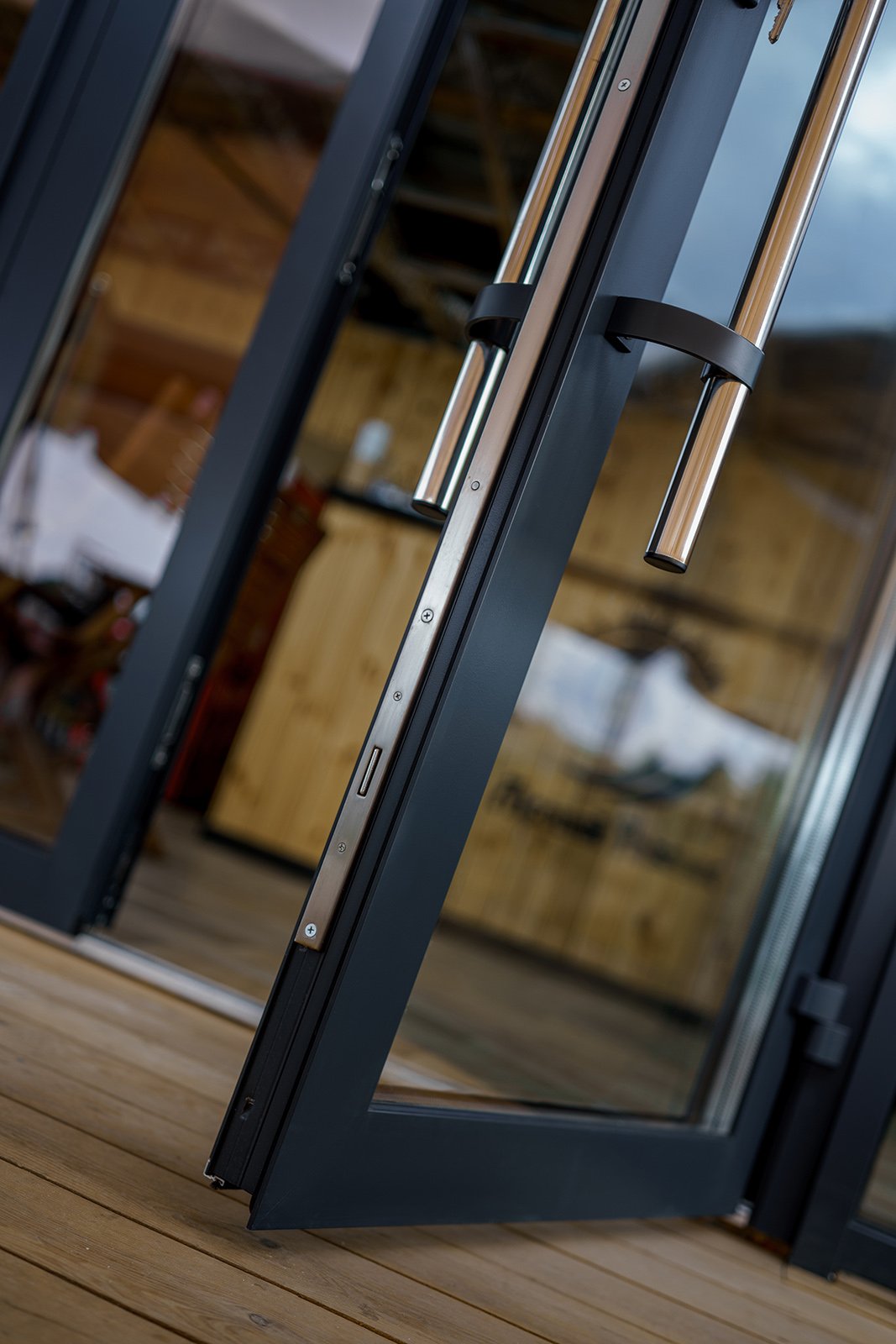 Charcoal aluminum double entry doors with stainless steel pulls in River Oaks Houston