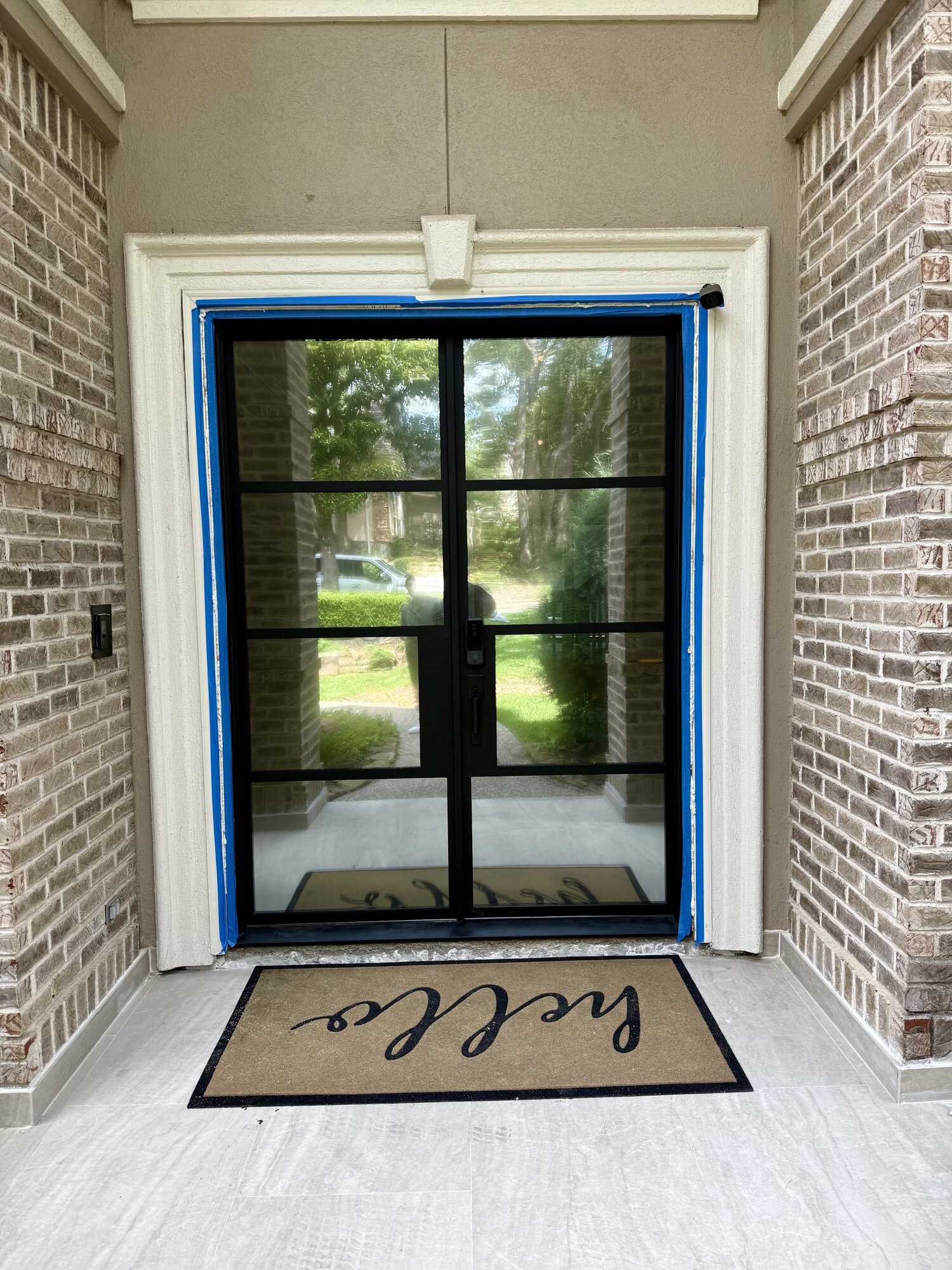 Humble TX entry door with one-way mirror glass — exterior mirrored view