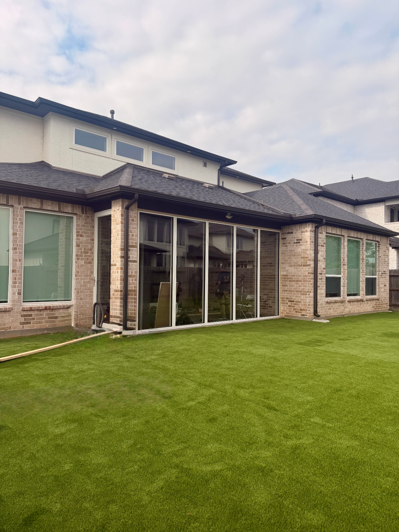 Sugar Land patio enclosure with aluminum picture windows — exterior view