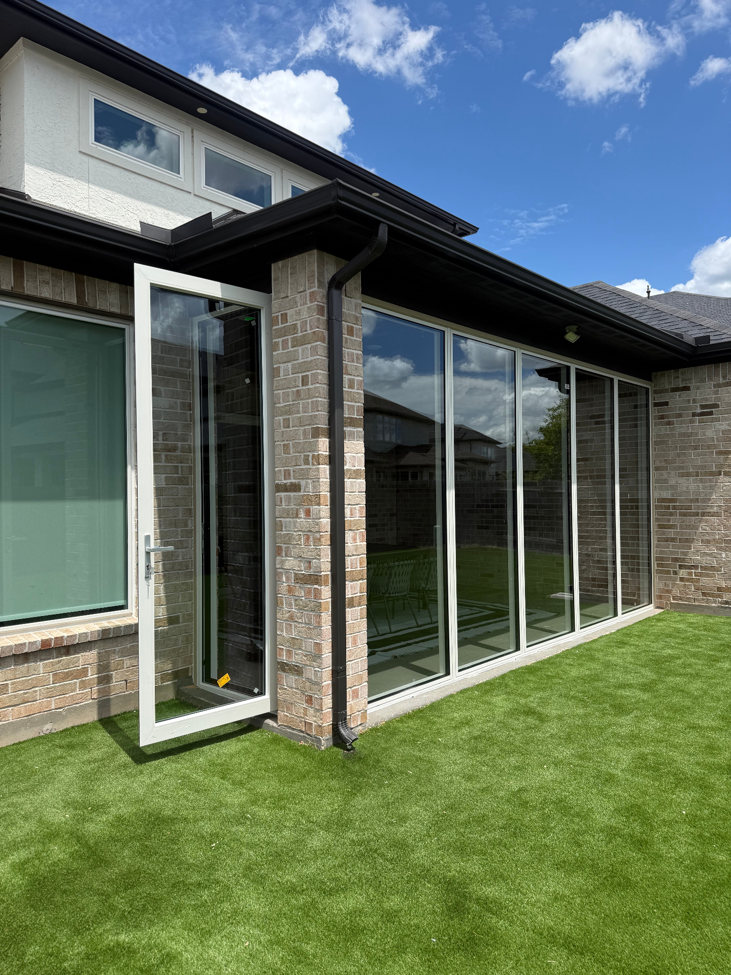 Sugar Land patio enclosure with casement door open to backyard