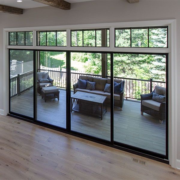 4-panel sliding patio door with transom windows overlooking deck