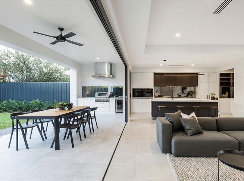 Open-concept kitchen and living with sliding door to outdoor entertaining